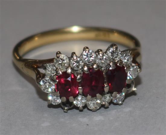 An 18ct gold, ruby and diamond triple cluster ring, (two diamonds missing), size U.